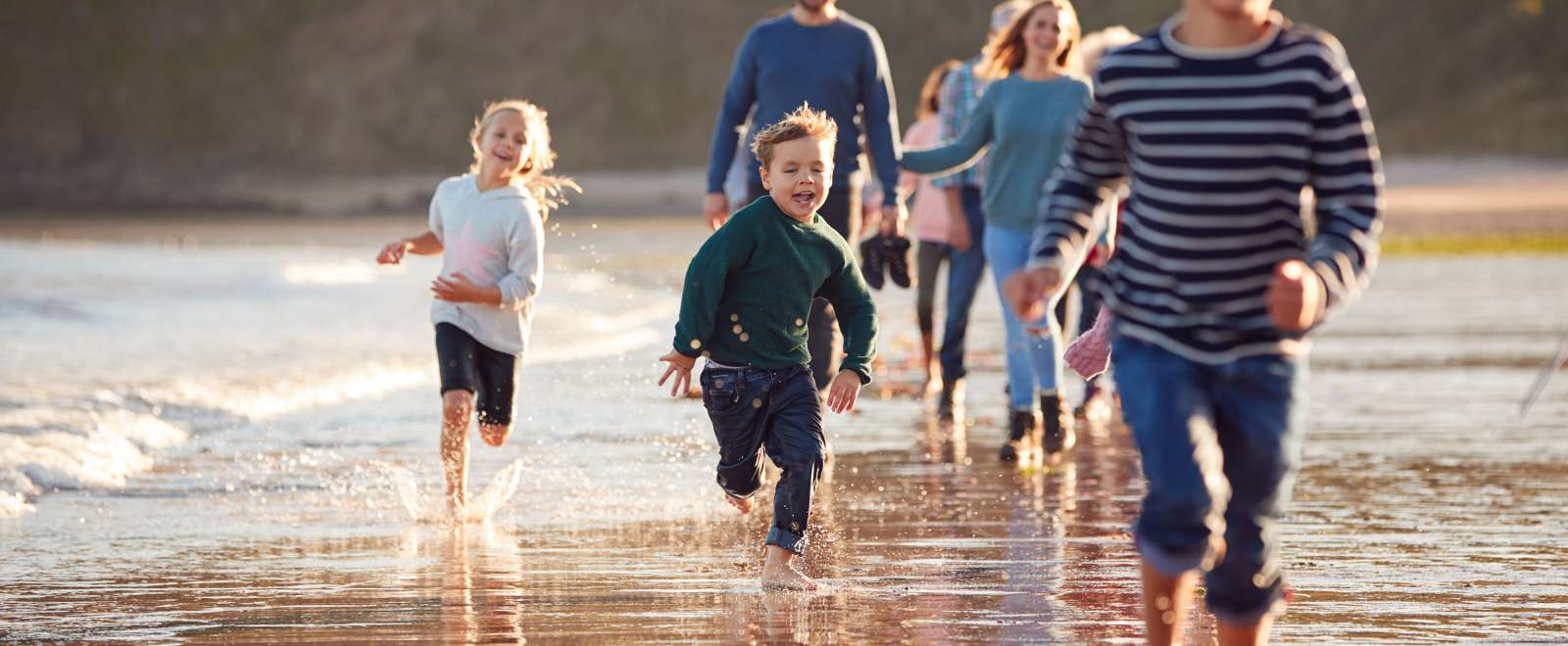 Family running along the coast 