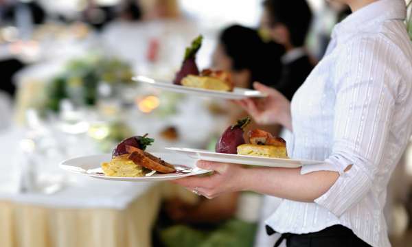 Waitress with plates of food at a Wedding Reception