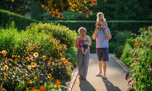 Young family in gardens at RHS Rosemoor