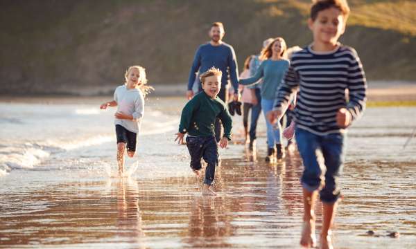 Family running along the coast 