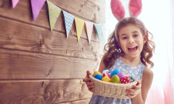Little girl with easter basket and bunny ears