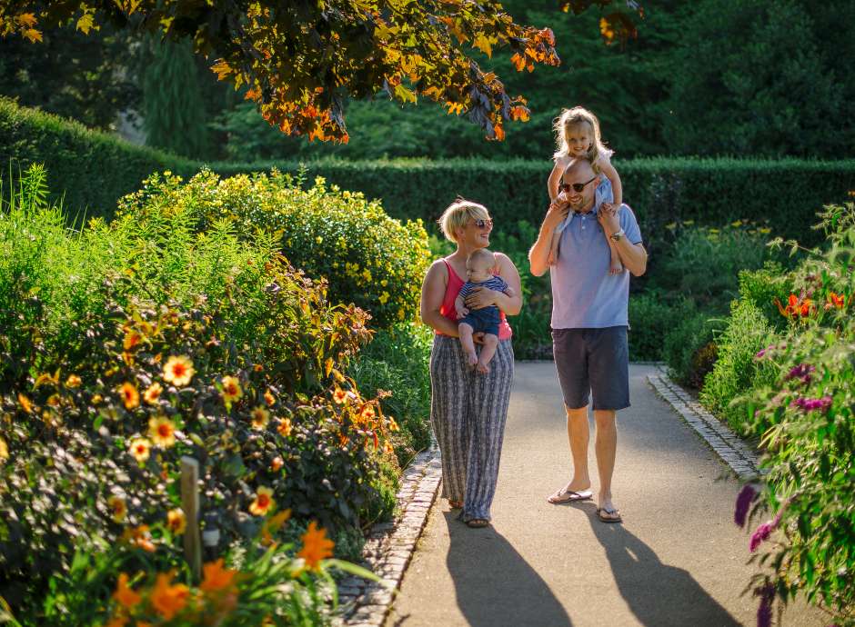 Young family in gardens at RHS Rosemoor