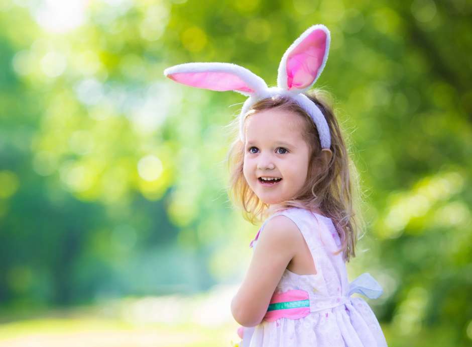 A little girl with bunny ears on her head