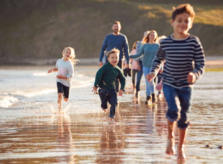 Family running along the coast 