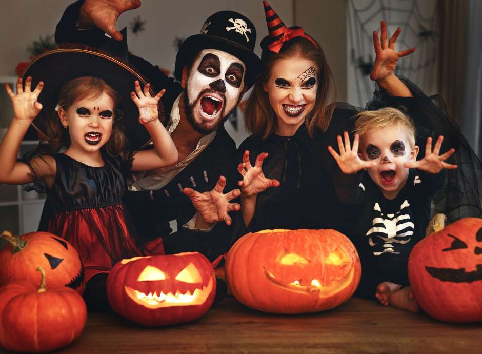 Family posing with pumpkins
