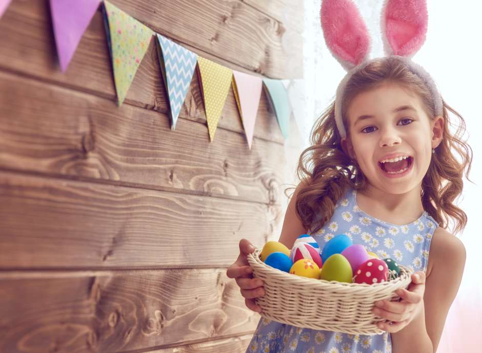 Little girl with easter basket and bunny ears